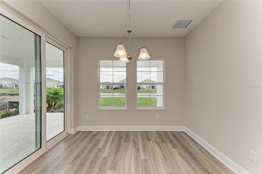 17915 Cropside Trail Lakewood Ranch, FL 34211 - Photo 20 of 33 an empty room with wooden floor and windows