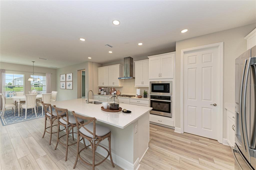17915 Cropside Trail Lakewood Ranch, FL 34211 - Photo 2 of 33 a kitchen with stainless steel appliances a stove top oven a sink refrigerator and cabinets