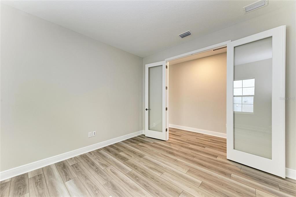 17915 Cropside Trail Lakewood Ranch, FL 34211 - Photo 29 of 33 a view of an empty room with wooden floor and a window