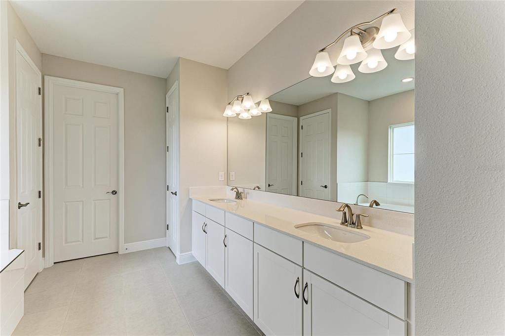 17915 Cropside Trail Lakewood Ranch, FL 34211 - Photo 7 of 33 a bathroom with a double vanity sink and a mirror