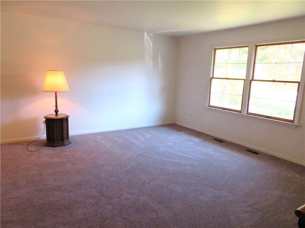 122 Clover Road Baden, PA 15005 - Photo 2 of 30 an empty room with a lamp and a window