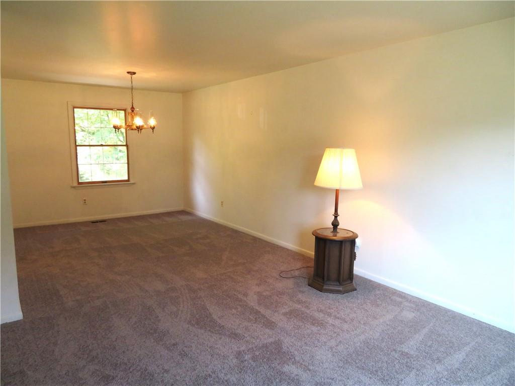 122 Clover Road Baden, PA 15005 - Photo 3 of 30 a room that has a window and a table