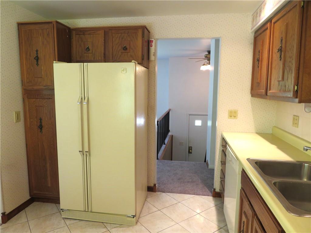 122 Clover Road Baden, PA 15005 - Photo 8 of 30 a kitchen with a refrigerator a sink and dishwasher