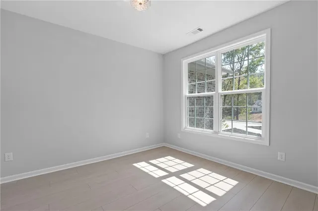 wooden floor in an empty room with a window
