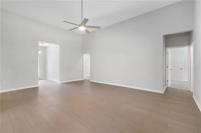 a kitchen with kitchen island granite countertop white cabinets and stainless steel appliances