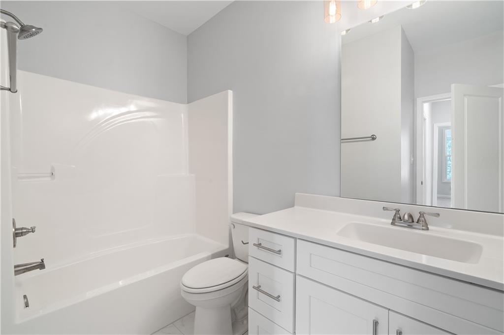 4477 Rivercliff Way Gray, GA 31032 - Photo 38 of 62 a bathroom with a sink and a mirror