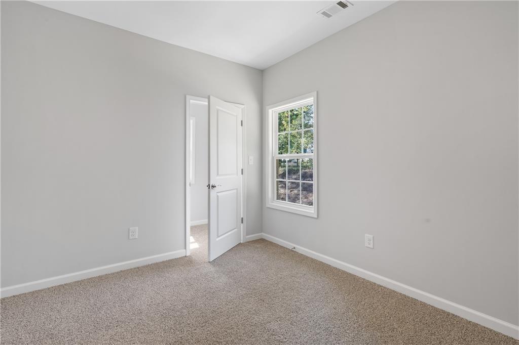 4477 Rivercliff Way Gray, GA 31032 - Photo 40 of 62 an empty room with windows