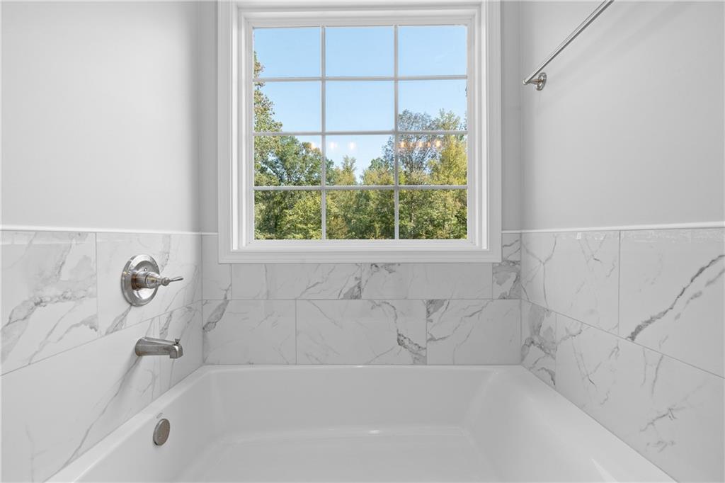 4477 Rivercliff Way Gray, GA 31032 - Photo 44 of 62 a bathroom with a bathtub and a window