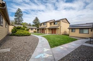713 12th Street La Grande, OR 97850 - Photo 5 of 8 a front view of a house with a garden and trees
