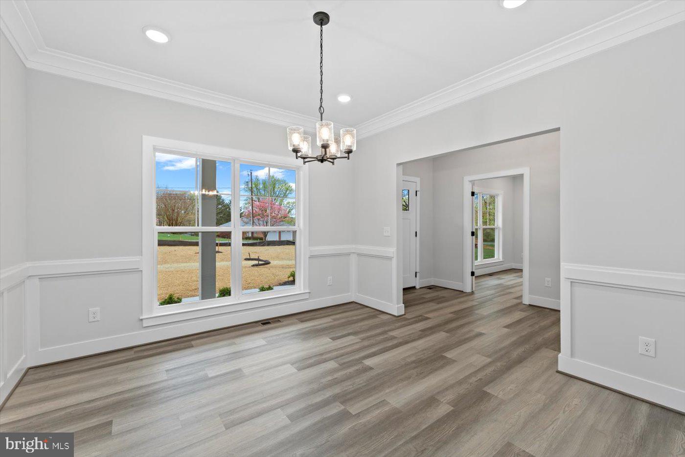 575 Solgrove Road Warrenton, VA 20186 - Photo 12 of 40 a view of a livingroom with wooden floor and a chandelier