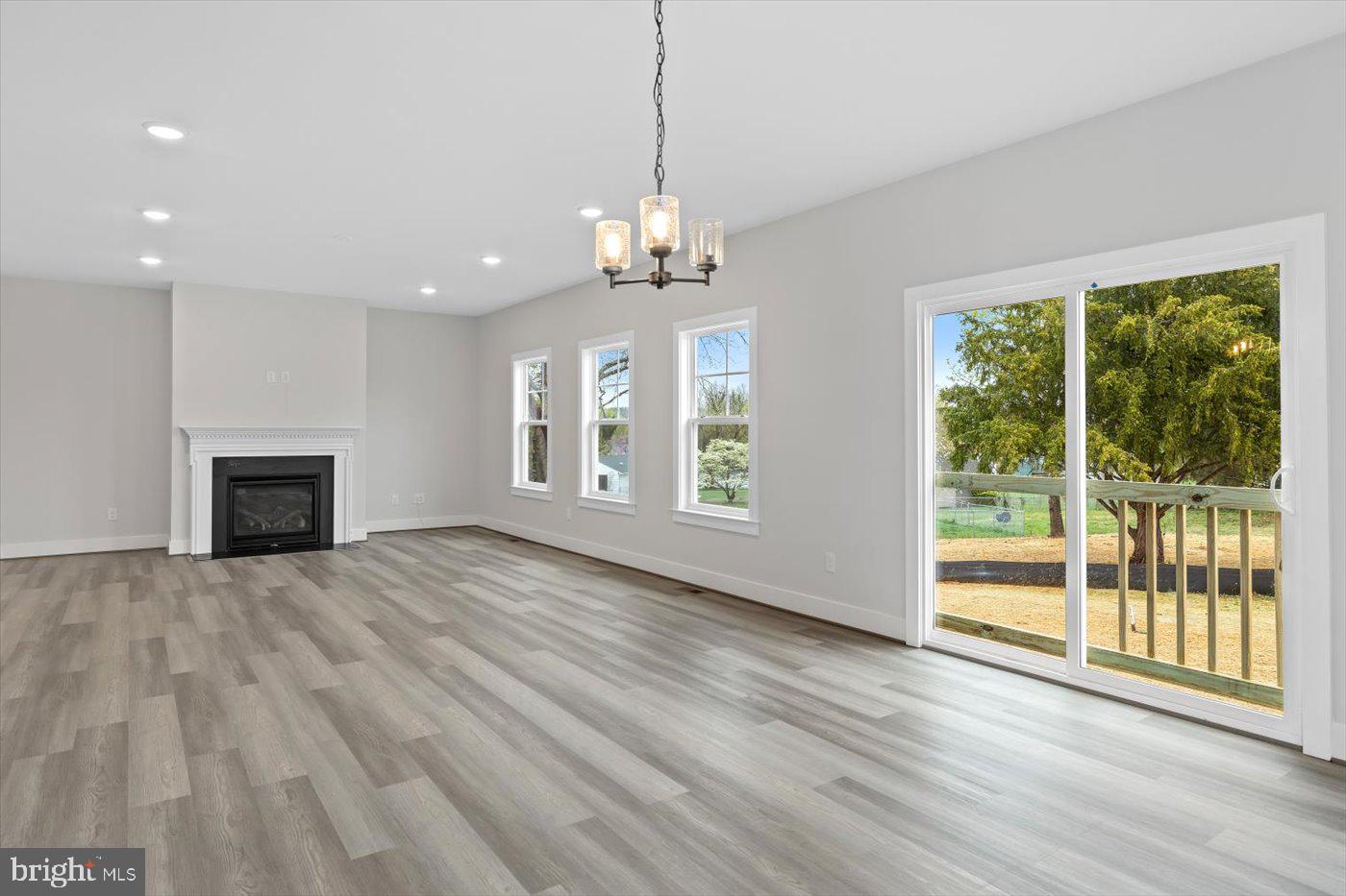 575 Solgrove Road Warrenton, VA 20186 - Photo 13 of 40 a view of an empty room with wooden floor and a window