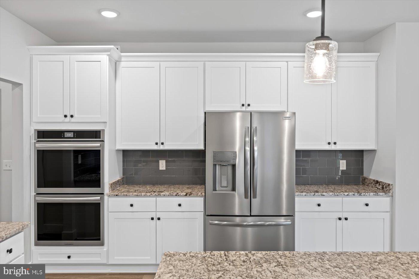 575 Solgrove Road Warrenton, VA 20186 - Photo 16 of 40 a kitchen with cabinets stainless steel appliances and wooden floor