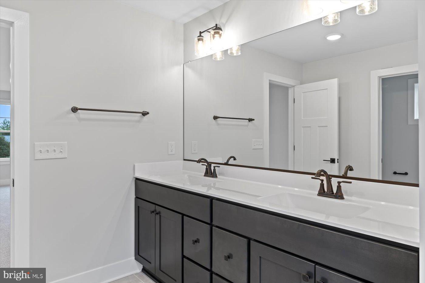 575 Solgrove Road Warrenton, VA 20186 - Photo 21 of 40 a bathroom with a double vanity sink and a mirror