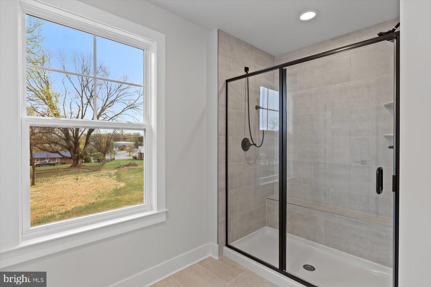 575 Solgrove Road Warrenton, VA 20186 - Photo 22 of 40 a bathroom with a glass shower door
