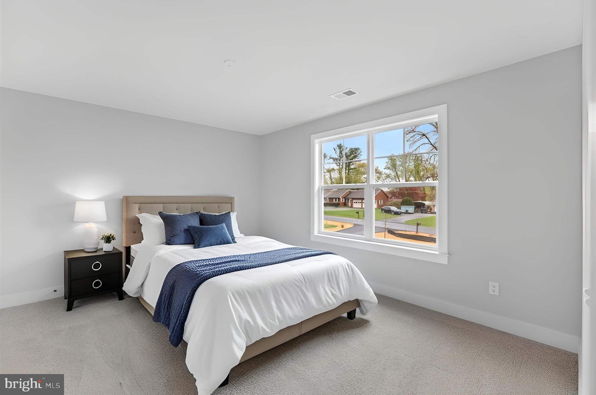 575 Solgrove Road Warrenton, VA 20186 - Photo 23 of 40 a bedroom with a bed lamp and window