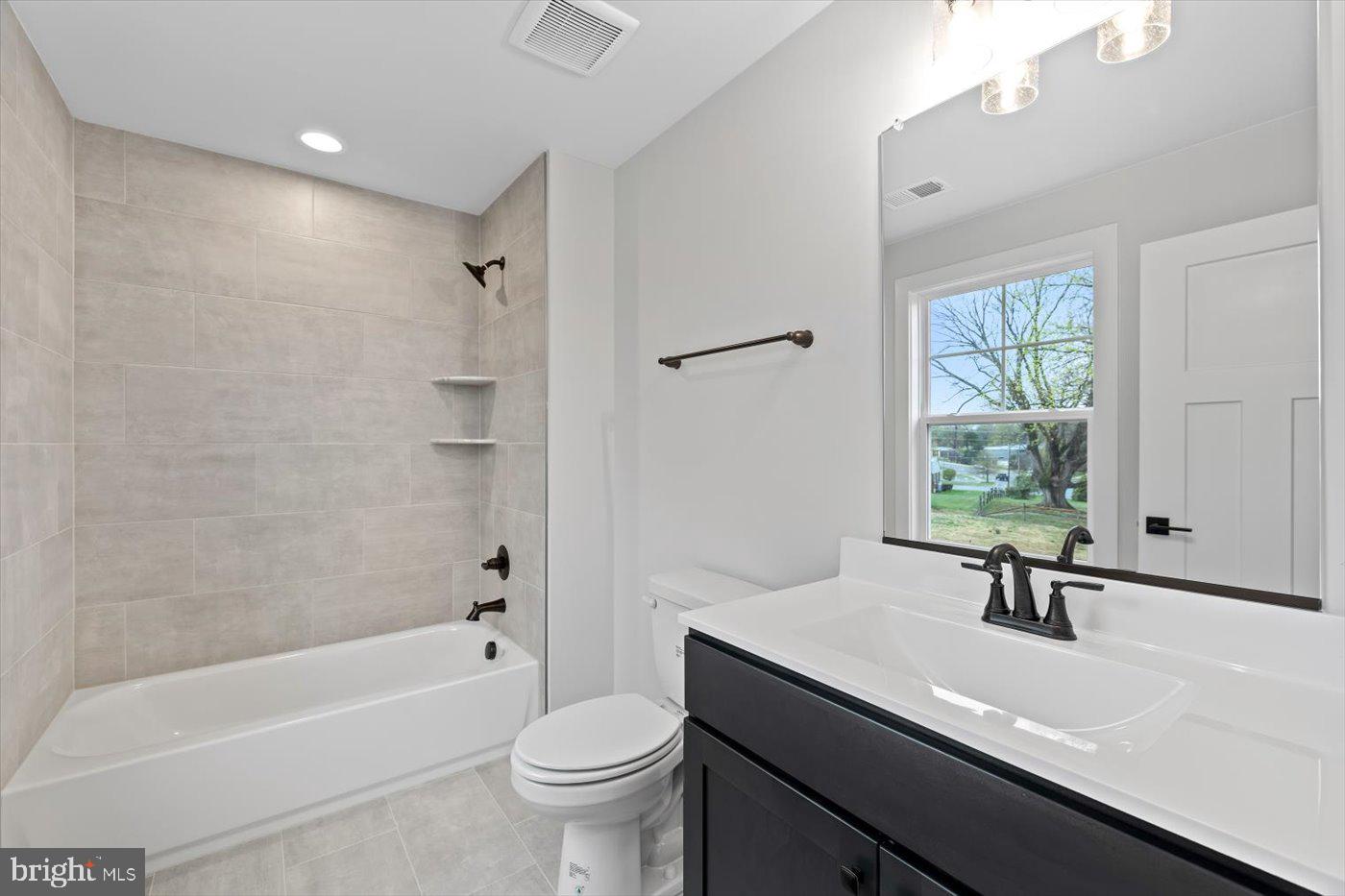 575 Solgrove Road Warrenton, VA 20186 - Photo 28 of 40 a bathroom with a sink a toilet a window and a mirror