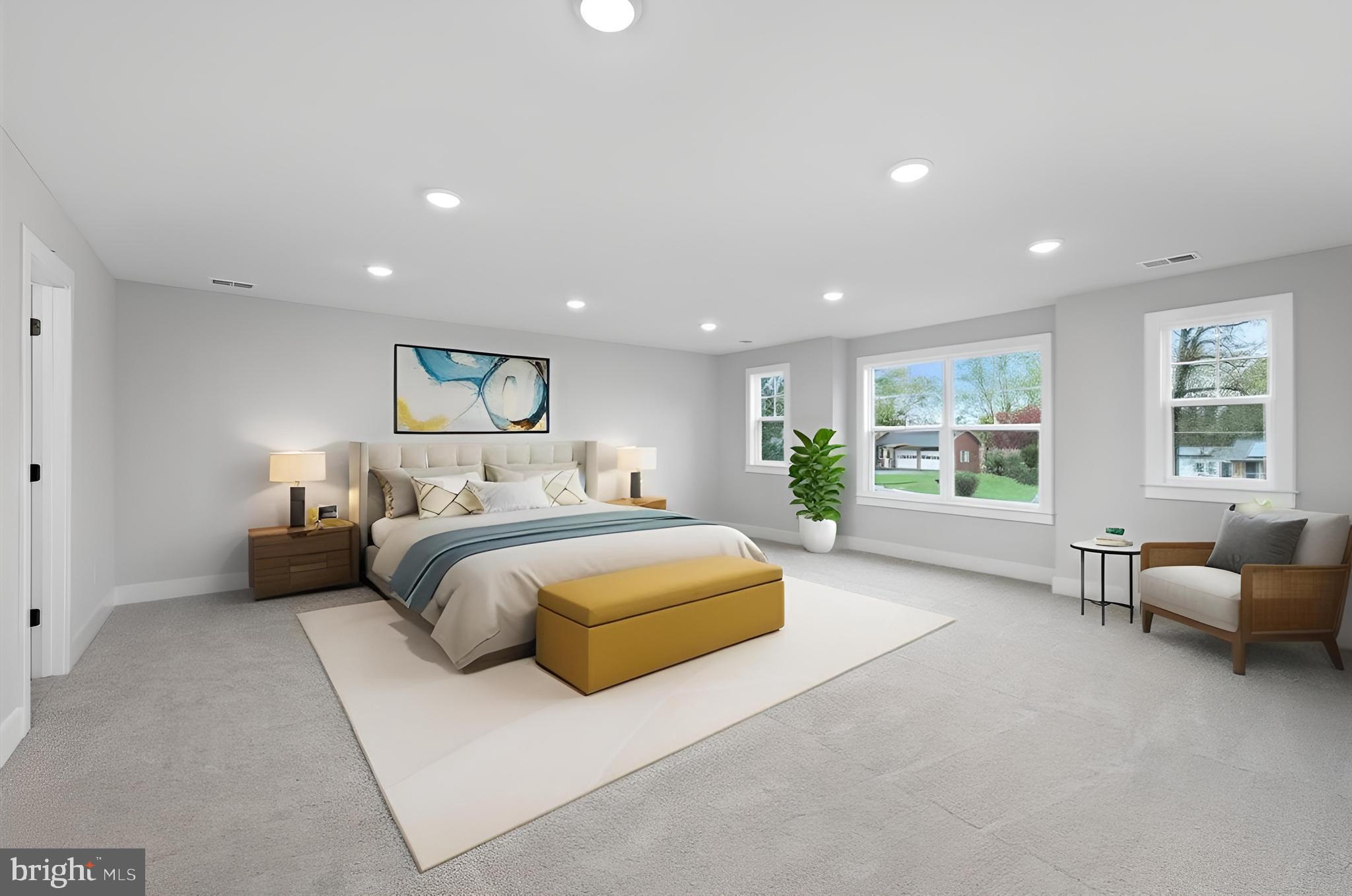 575 Solgrove Road Warrenton, VA 20186 - Photo 6 of 40 a spacious bedroom with a large bed and a couch