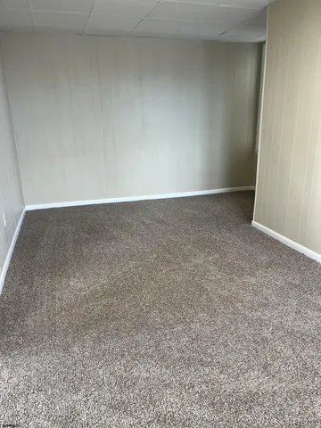 an empty room with large windows