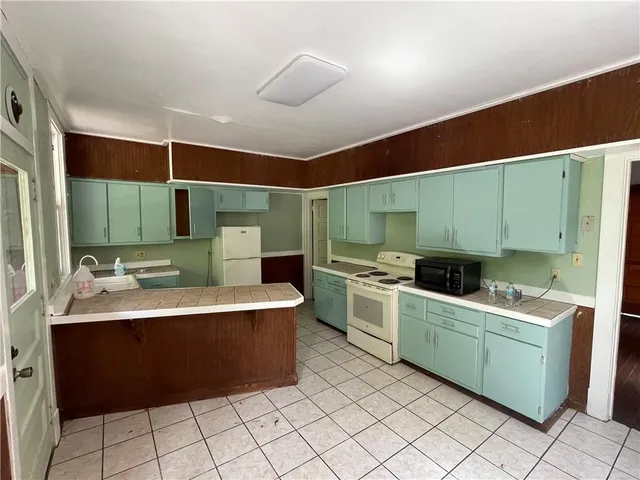 a kitchen with a sink appliances and cabinets