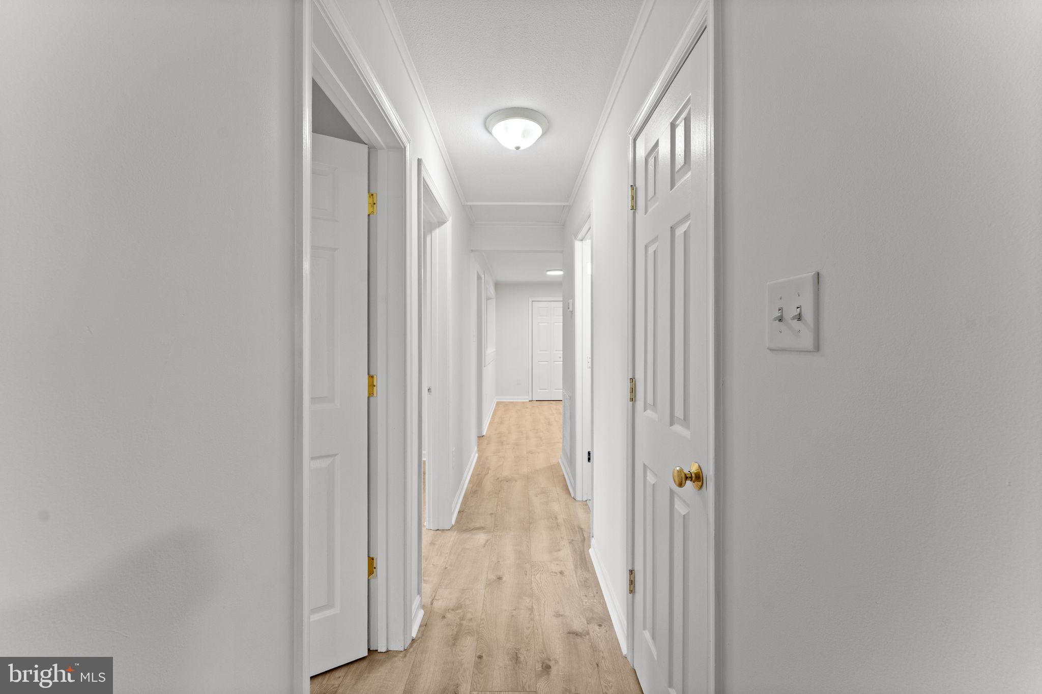 1821 James City Road Reva, VA 22735 - Photo 23 of 44 a view of a hallway with wooden floor and a bathroom