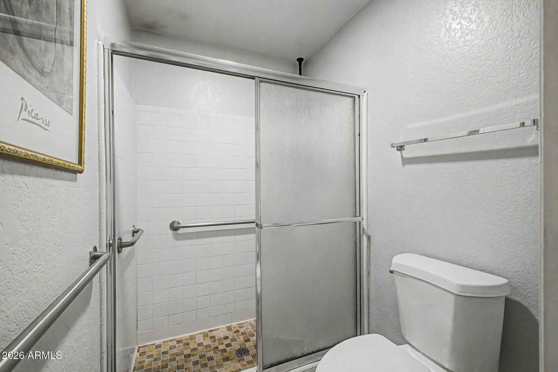 2659 West Hearn Road Phoenix, AZ 85023 - Photo 16 of 25 a white toilet sitting next to a shower