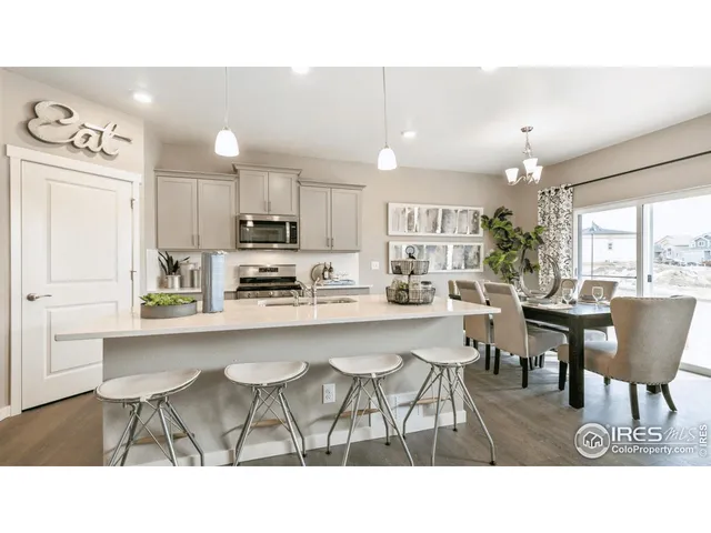 a kitchen with a dining table chairs and window