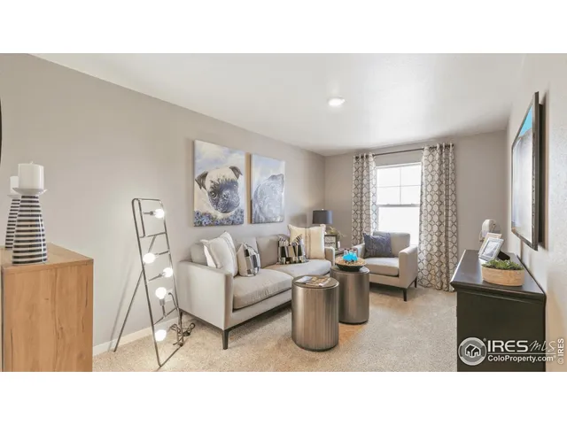 a living room with furniture a window and a flat screen tv