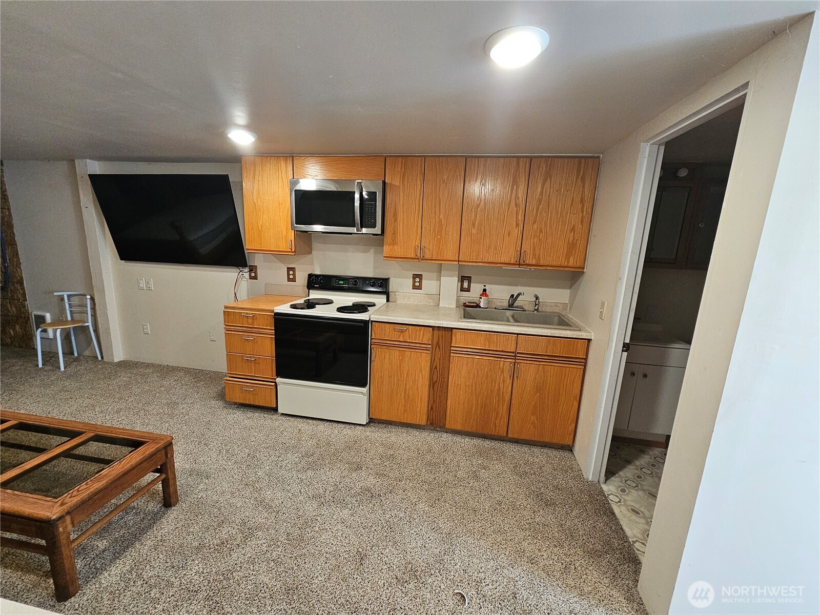 1210 Stella Road Longview, WA 98632 - Photo 13 of 28 a kitchen with microwave a sink and cabinets