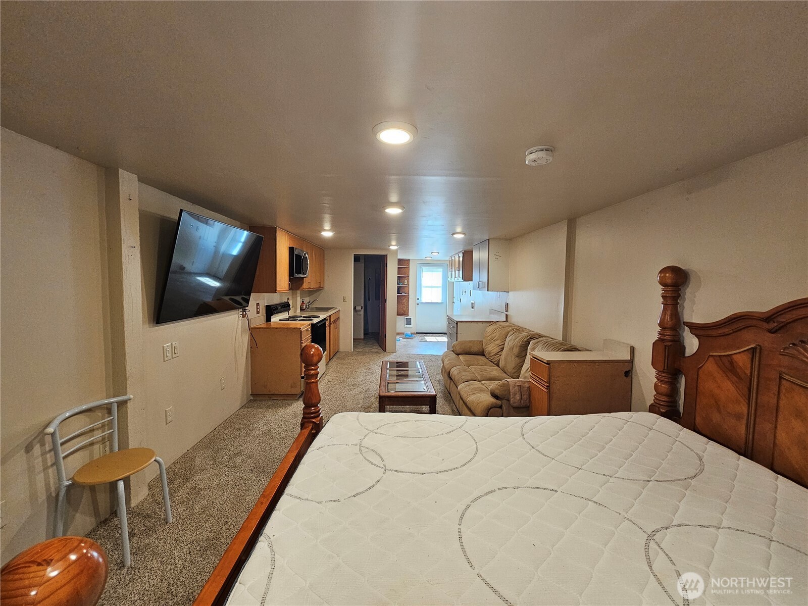 1210 Stella Road Longview, WA 98632 - Photo 15 of 28 a bed room with furniture and a flat screen tv