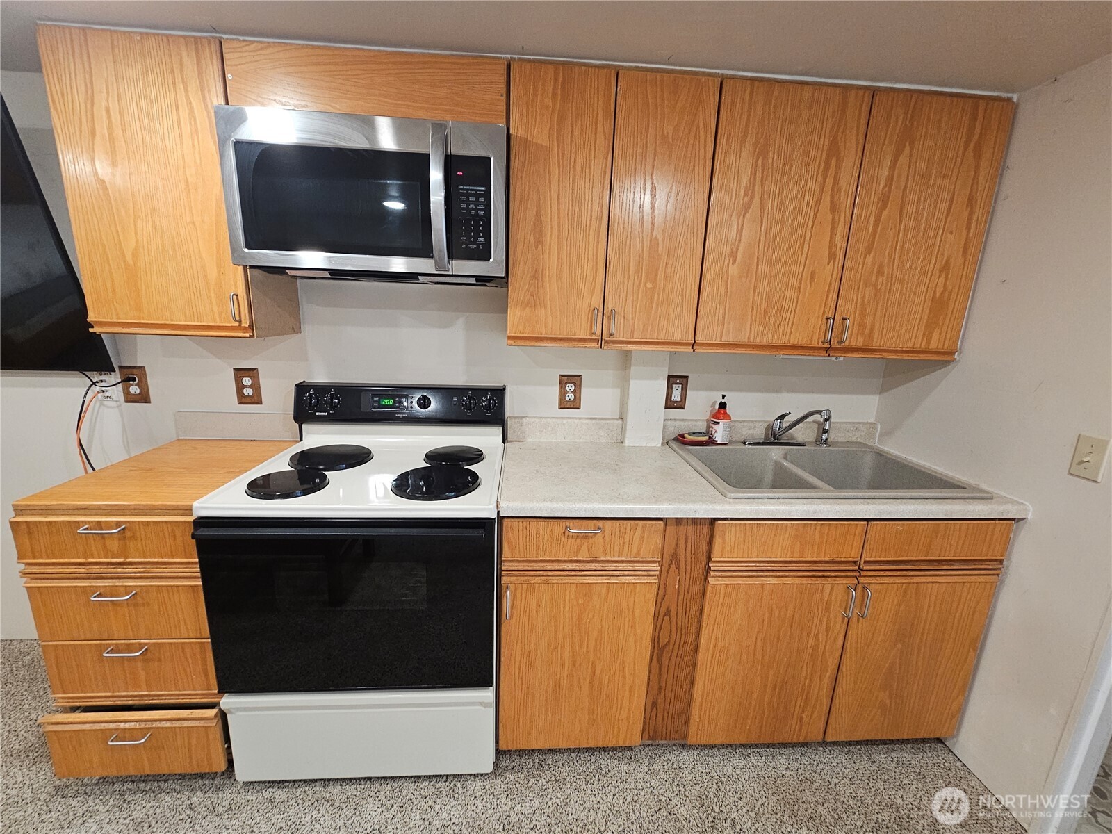 1210 Stella Road Longview, WA 98632 - Photo 16 of 28 a kitchen with stainless steel appliances a stove a microwave sink and cabinets