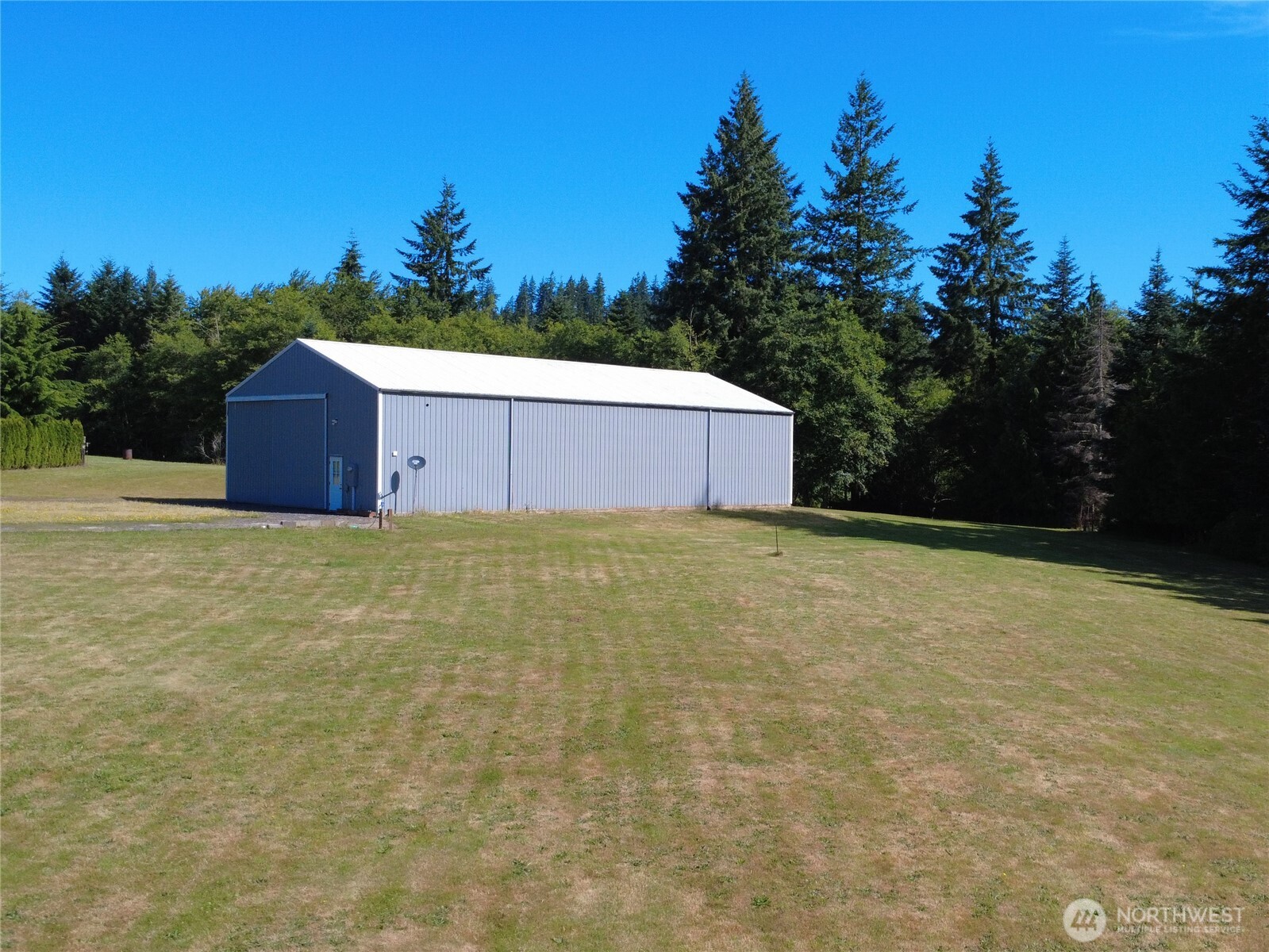 1210 Stella Road Longview, WA 98632 - Photo 2 of 28 a white house with a yard and wooden fence