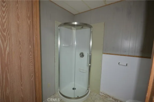 a bathroom with a glass shower door