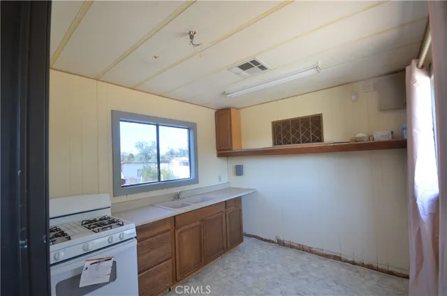 a kitchen with stainless steel appliances granite countertop a sink stove and cabinets