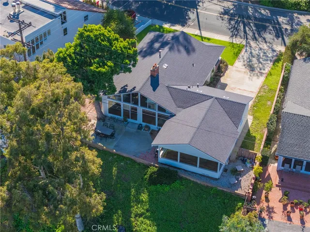 an aerial view of house with yard swimming pool and outdoor seating