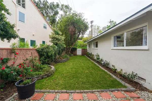a backyard of a house with table and chairs
