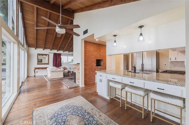 a large room with lots of wooden furniture and windows