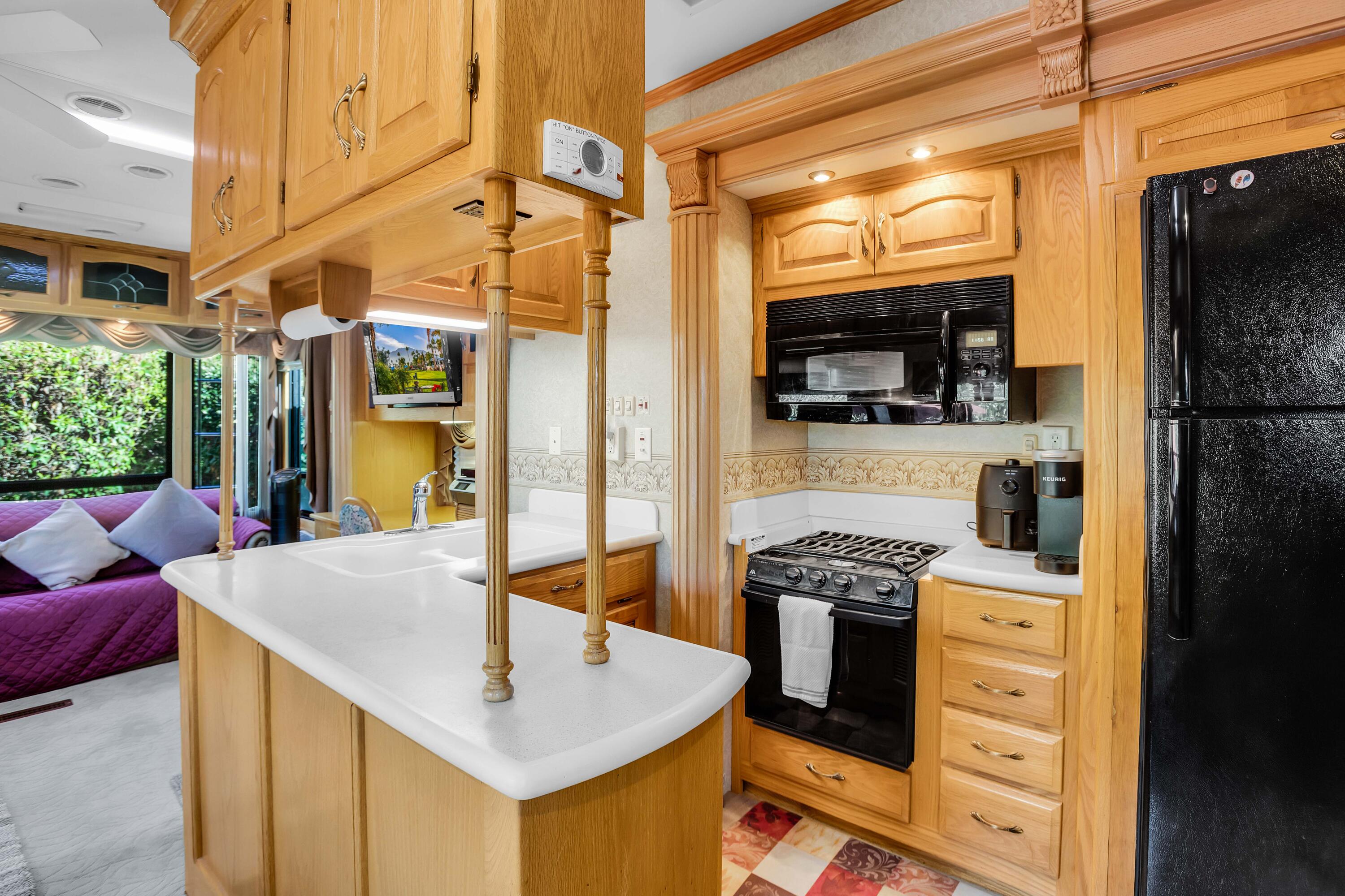 69411 Ramon Road, Unit 360 Cathedral City, CA 92234 - Photo 13 of 66 a kitchen with stainless steel appliances granite countertop a stove and a refrigerator