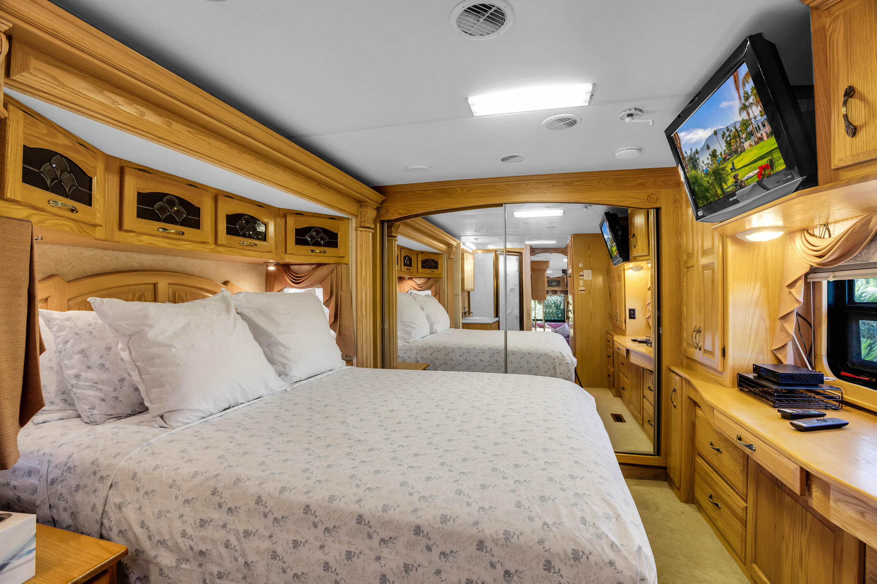 69411 Ramon Road, Unit 360 Cathedral City, CA 92234 - Photo 5 of 66 a spacious bedroom with a bed a mirror on dresser and a flat screen tv