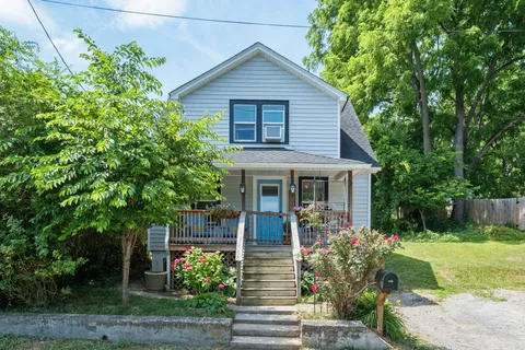 a front view of a house with garden