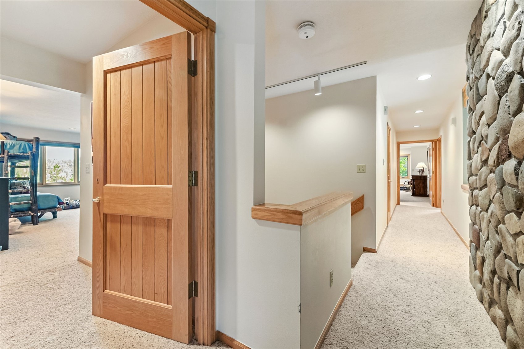 272 Penstemon Road Keystone, CO 80435 - Photo 25 of 50 Hallway at the top of the stairs, with glimpse of the special bunk room!