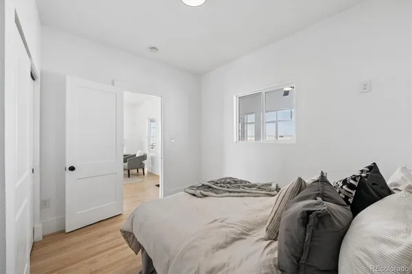 a bedroom with a bed and a window