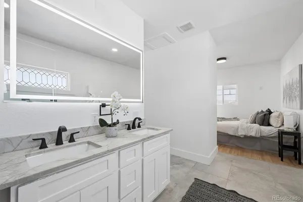 a bathroom with a double vanity sink and mirror