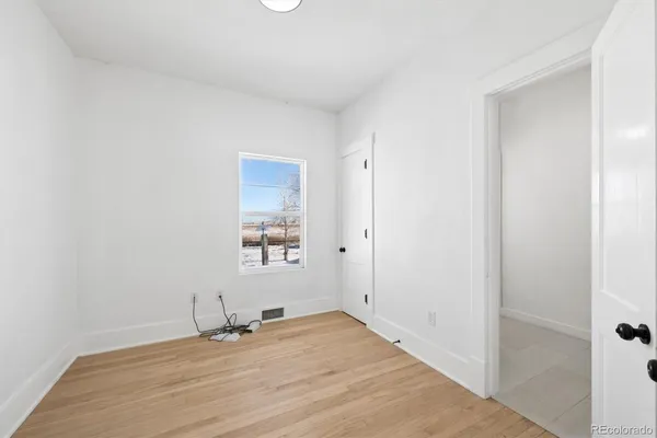 a view of a room with wooden floor and a sink