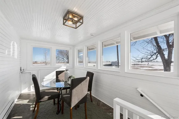 a dining room with furniture and window