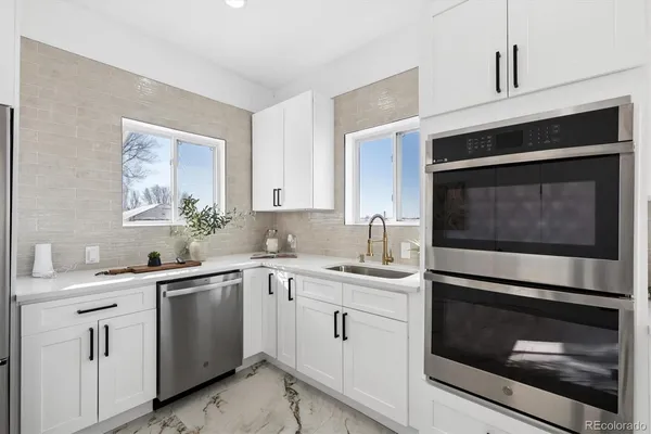 a kitchen with a sink stove and microwave
