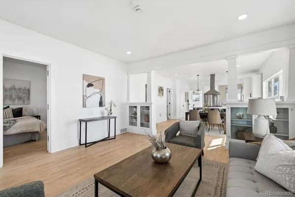 a living room with furniture and a wooden floor