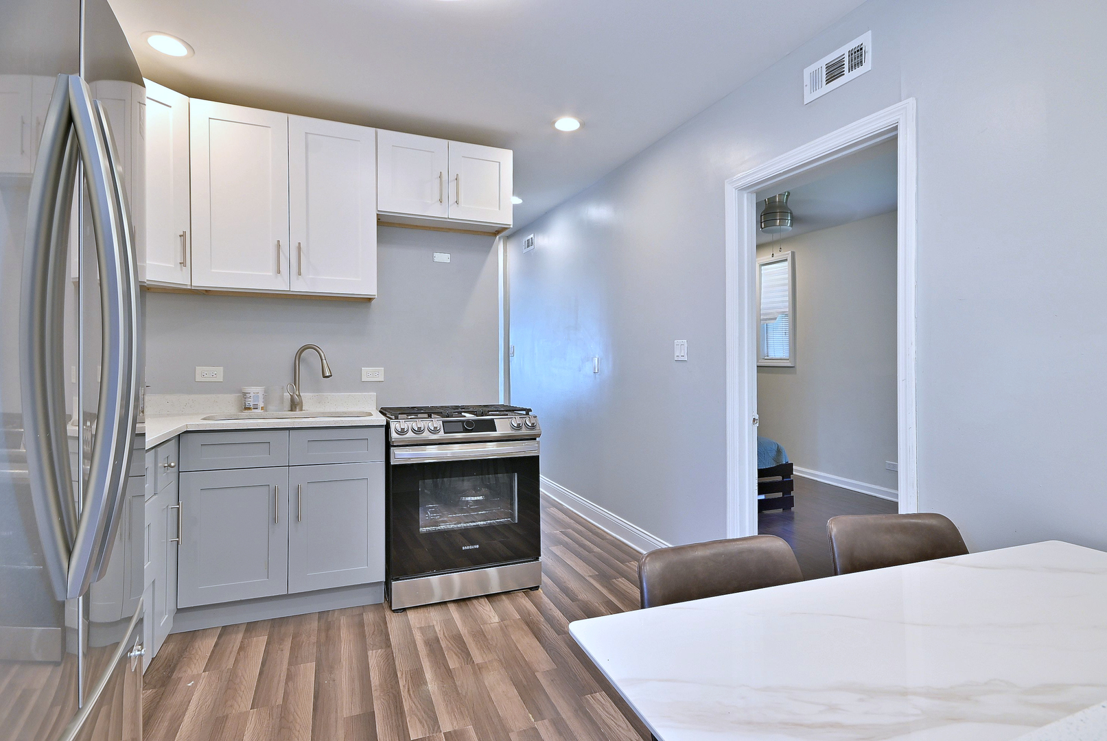 5125 South Elizabeth Street Chicago, IL 60609 - Photo 13 of 61 a kitchen with stainless steel appliances granite countertop a stove a sink and a refrigerator