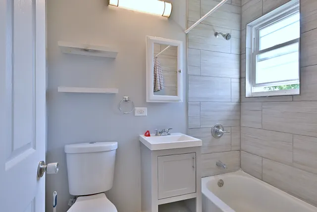a kitchen with cabinets appliances and a dining table