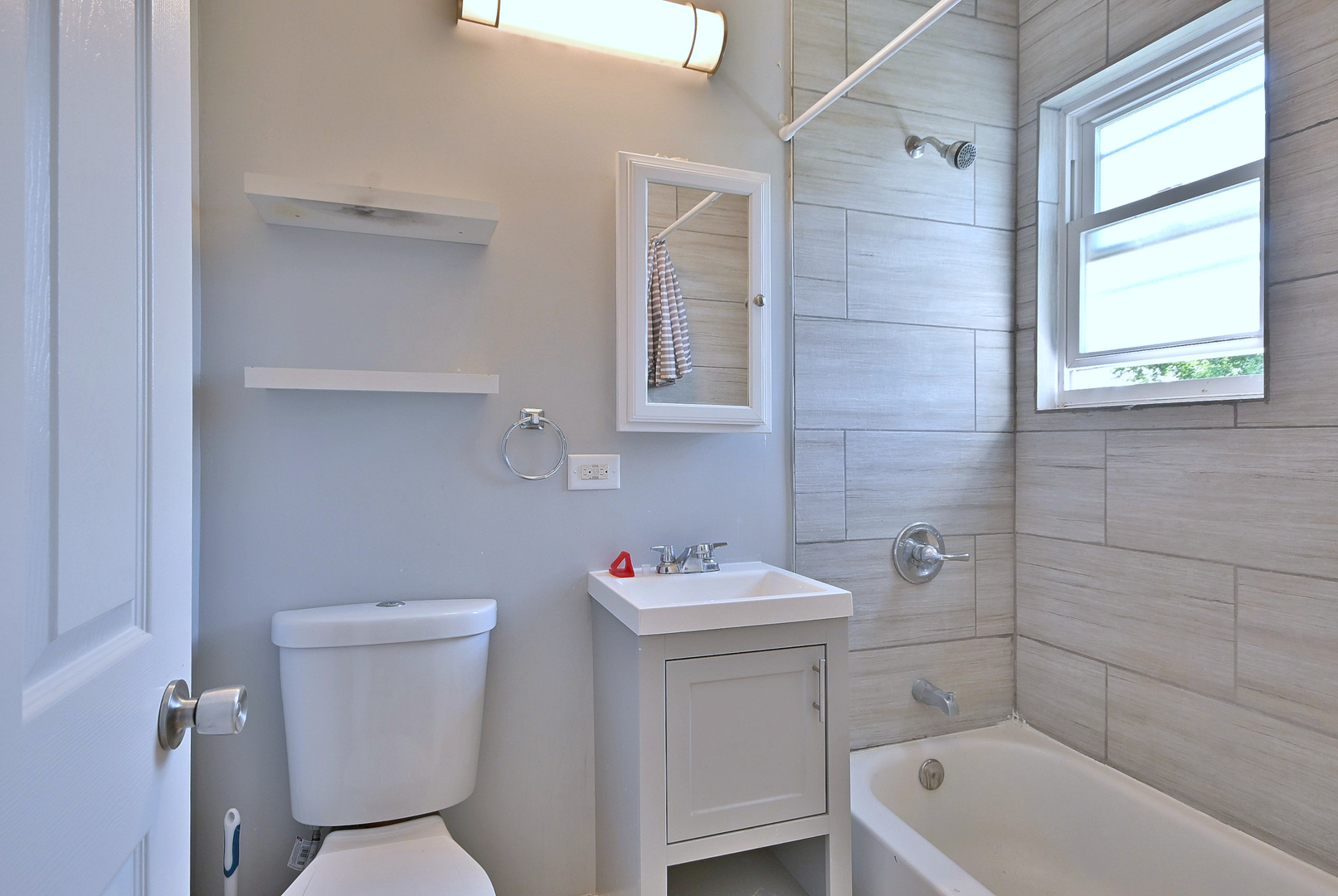 5125 South Elizabeth Street Chicago, IL 60609 - Photo 28 of 61 a bathroom with a sink toilet and window