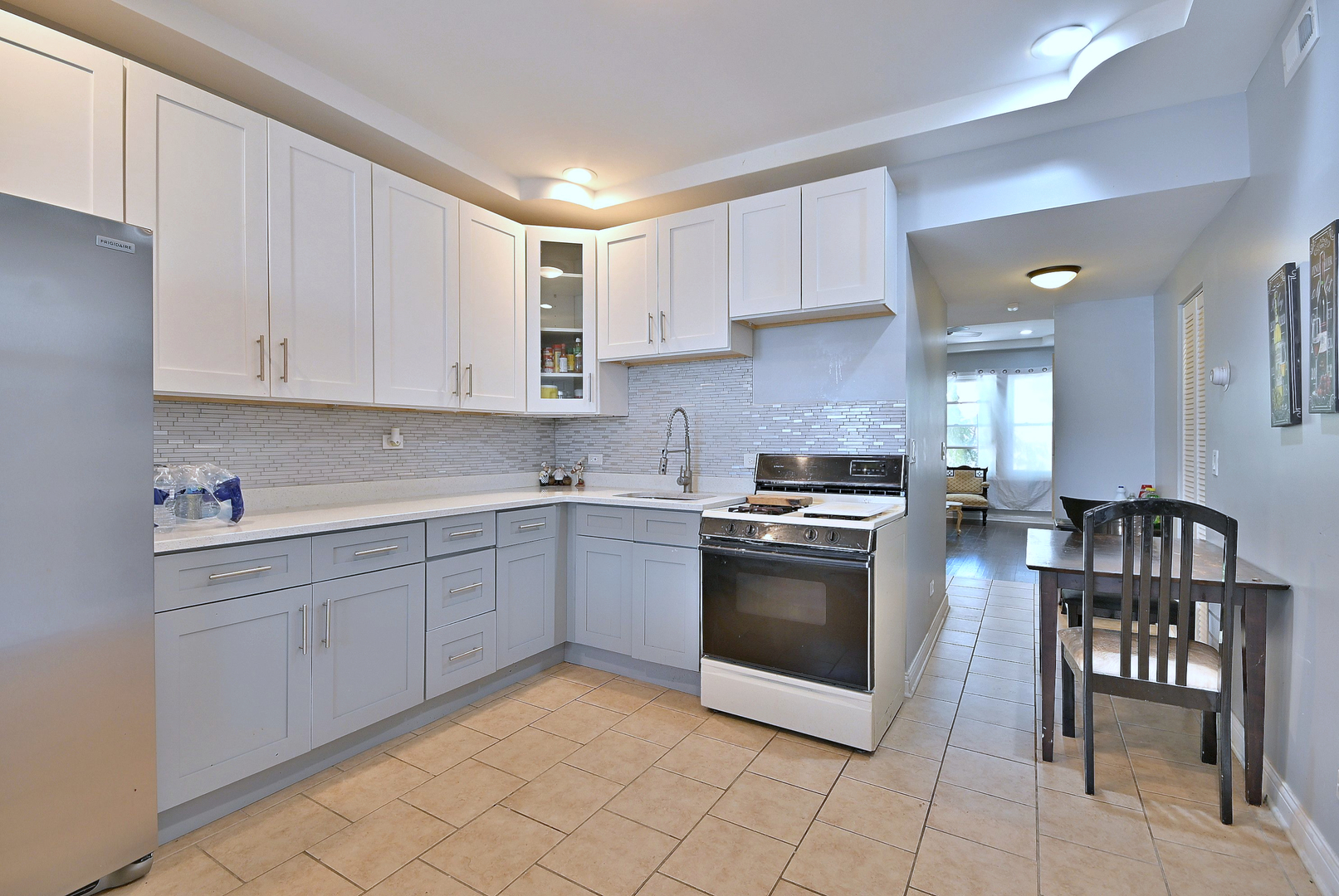5125 South Elizabeth Street Chicago, IL 60609 - Photo 34 of 61 a kitchen with cabinets appliances and a dining table
